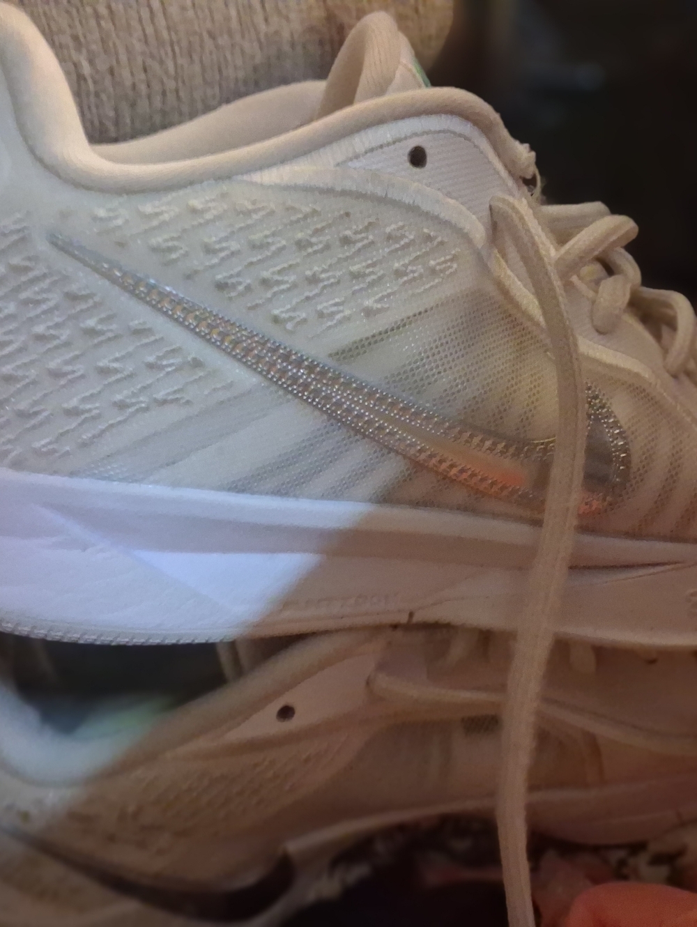 Nike Women’s White Athletic Sneakers with Metallic Silver Swoosh